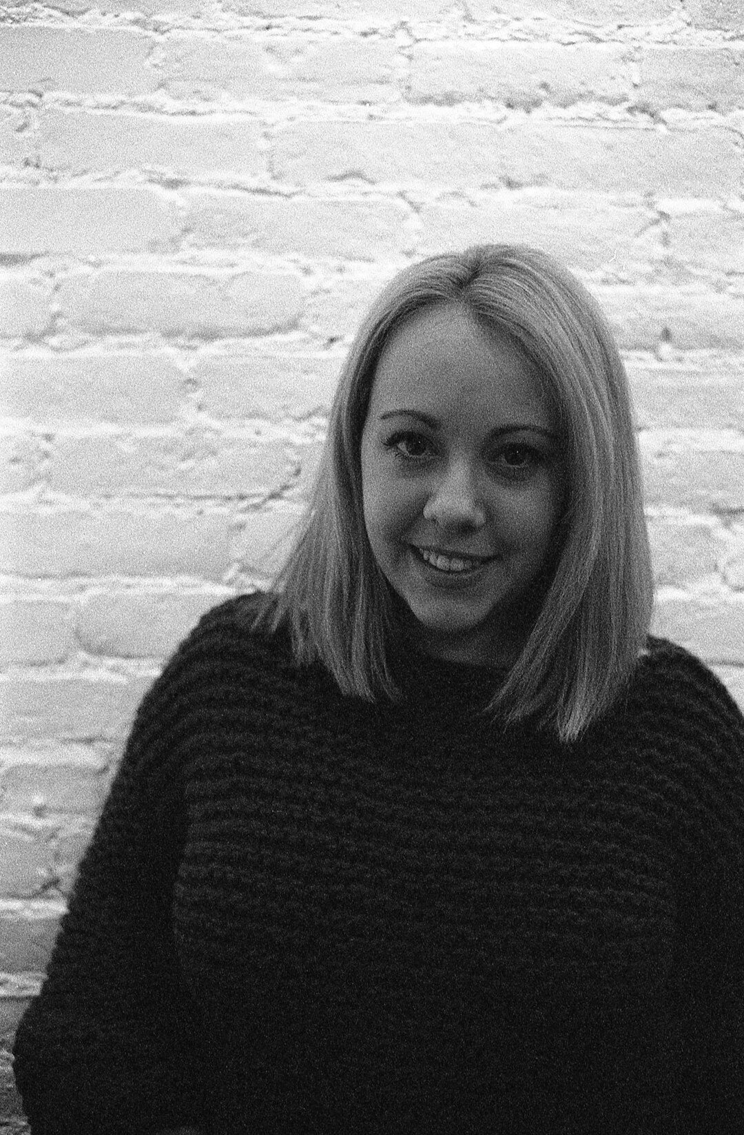Studio portrait of a woman with short blonde hair smiling